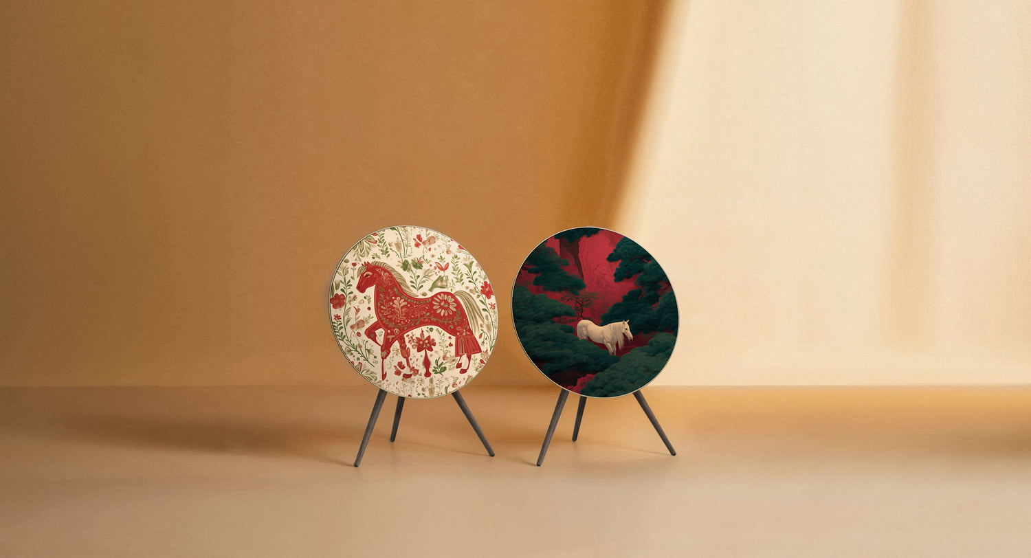 Bang & Olufsen BeoPlay A9 and BeoSound A9 speaker covers Lucky Trot and Ivory Pine by Tegrino Studio featuring folk art red horse illustration alongside white horse in dark pine forest scene