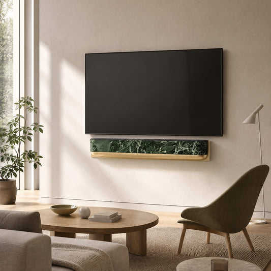 Bang & Olufsen BeoSound Theatre skin in Verde St. Denis green marble design mounted below wall TV in luxe living room with fluted gold and sage green paneling, brass side tables