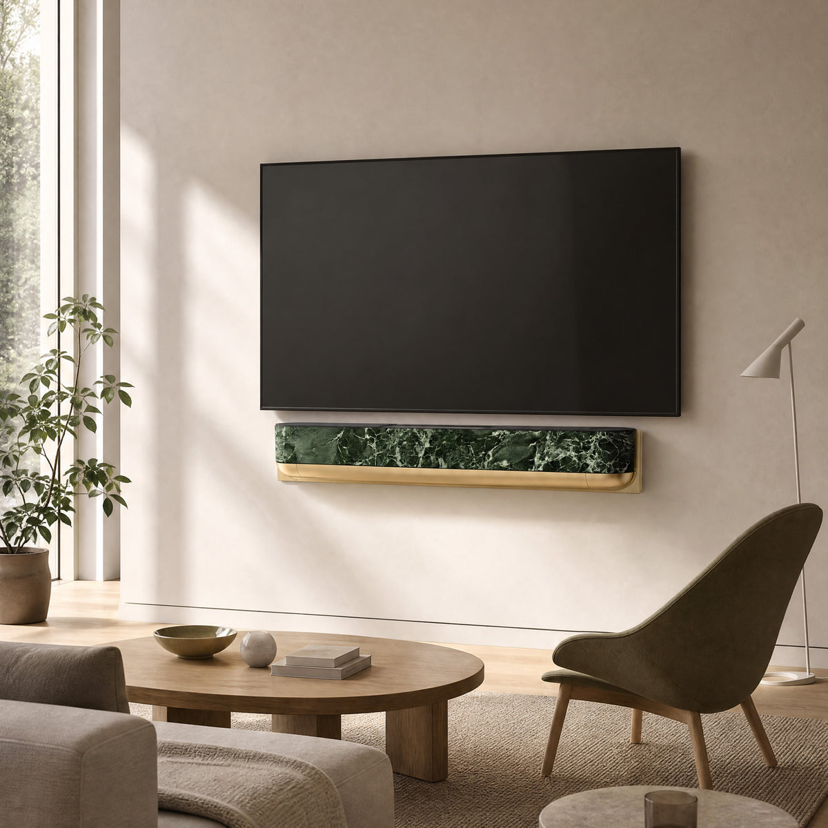 Bang & Olufsen BeoSound Theatre skin in Verde St. Denis green marble design mounted below wall TV in luxe living room with fluted gold and sage green paneling, brass side tables