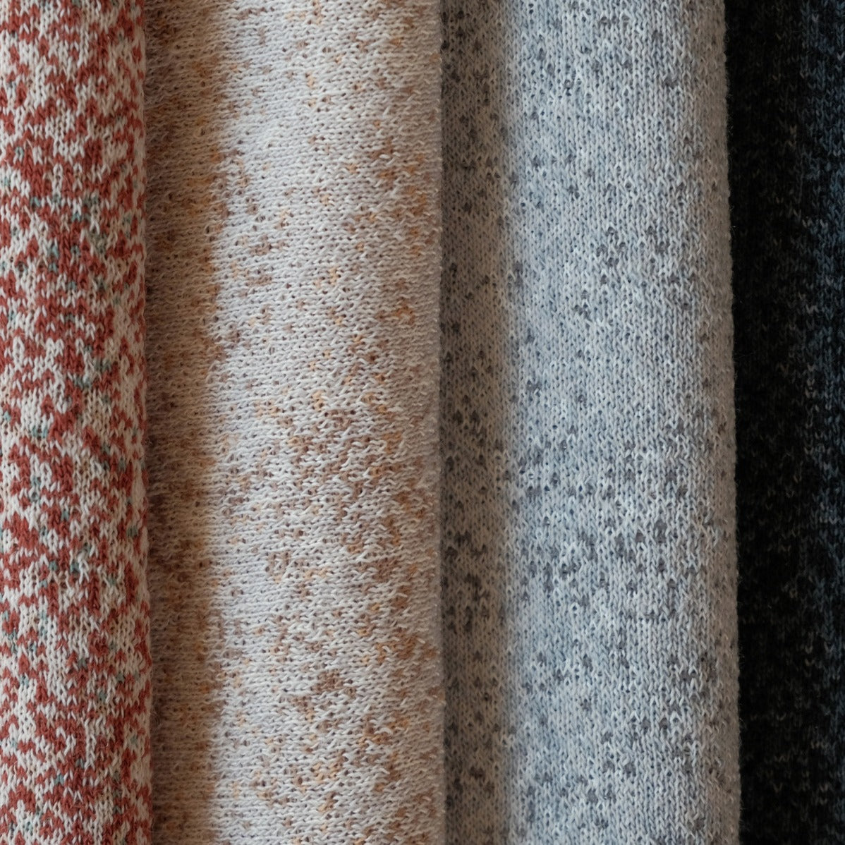 Kvadrat Woolscape double-knitted wool textiles for the Beoplay and Beosound A9 cover, side by side in Mineral Red, Golden, Light Grey and Dark Grey, close-up of the knit