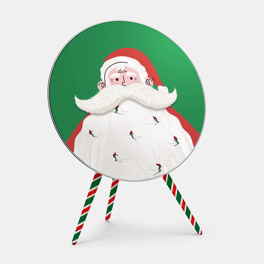 Bang & Olufsen Beoplay A9 speaker cover Santa Slopes by Tegrino Studio, tiny skiers carving down Santa's white beard against festive green, printed on acoustically transparent fabric, shown with the matching striped legs cover