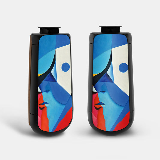 Bang & Olufsen BeoLab 50 speaker covers Éclat — Cubist Portrait by Tegrino Studio featuring cubist abstract face in vivid blue, white, pink and red geometric planes rising up the tall capsule form on stereo pair, printed on acoustically transparent fabric