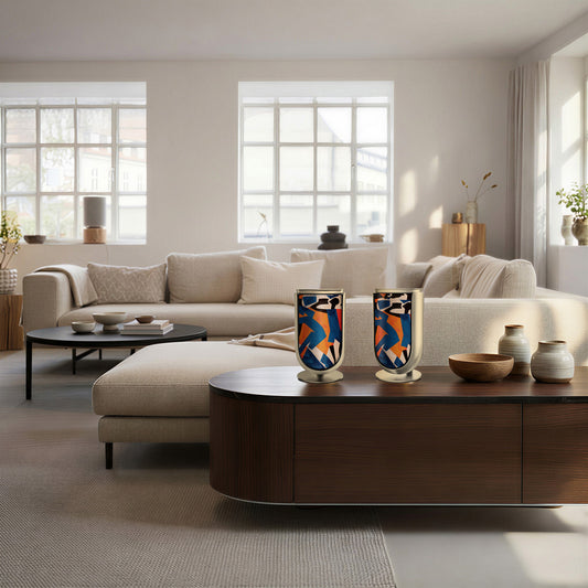 Bang & Olufsen BeoLab 8 speaker covers Verve by Tegrino Studio in a Scandinavian-inspired environment, presenting bold figurative silhouettes in vivid blue, orange and red on stereo pair atop dark walnut sideboard in bright minimal living room with cream sofa and natural light