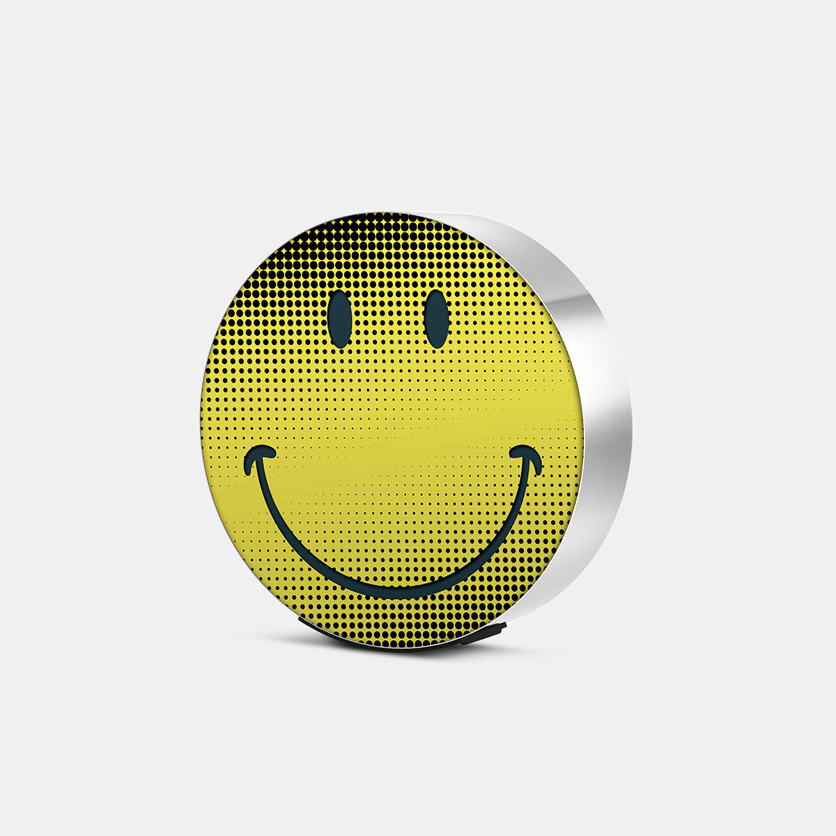 Bang & Olufsen BeoSound Edge cover replacement featuring Be Happy pop-art halftone smiley face design in yellow and black, brushed silver metal edge, printed on acoustically transparent fabric, angled product view on white background
