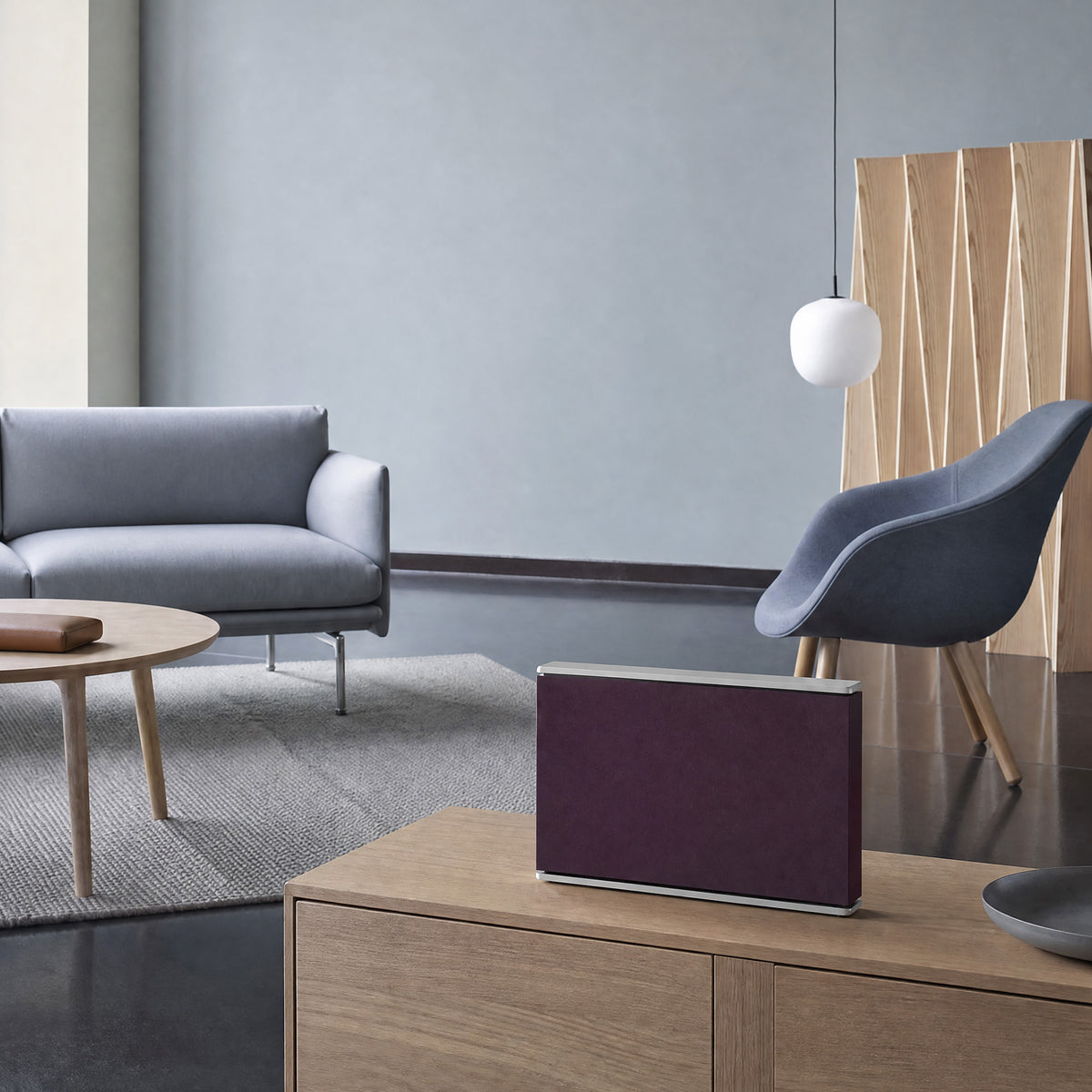 Bang & Olufsen Beosound Level with the Damson cover by Tegrino Studio on a light oak sideboard in front of a grey sofa