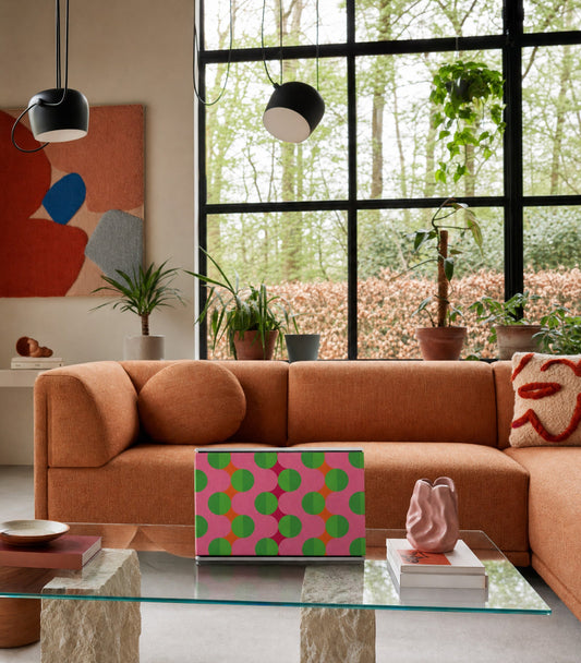 Bang & Olufsen Beosound Level with the Summer Beat cover by Tegrino Studio on a glass table below tall black-framed windows