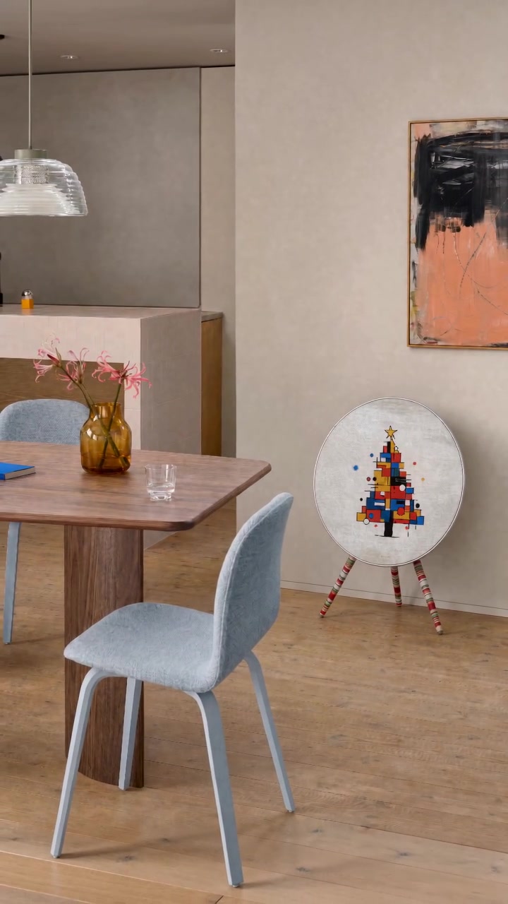 Mondrian Noël cover with the candy-cane striped legs cover by Tegrino Studio on a Bang & Olufsen Beosound A9, a beagle sniffing around it in a dining room