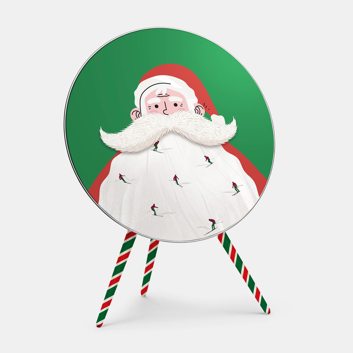 Bang & Olufsen Beoplay A9 speaker cover Santa Slopes by Tegrino Studio, tiny skiers carving down Santa's white beard against festive green, printed on acoustically transparent fabric, shown with the matching striped legs cover